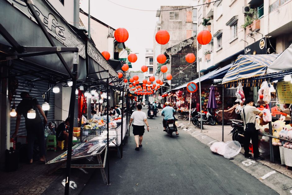 A bustling street food market in China with various vendors and delicious local dishes