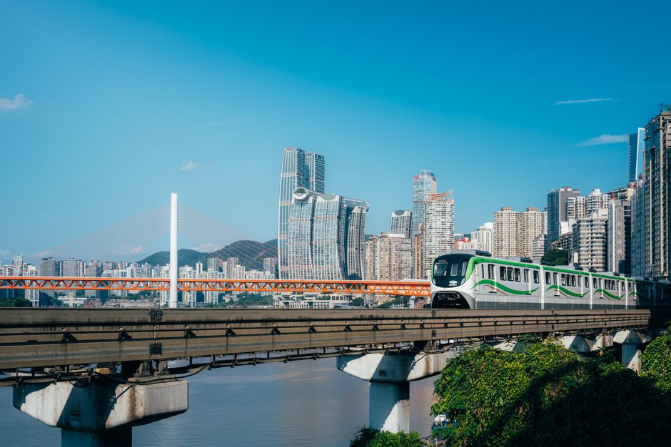 Modern high-speed train speeding through a scenic Chinese landscape