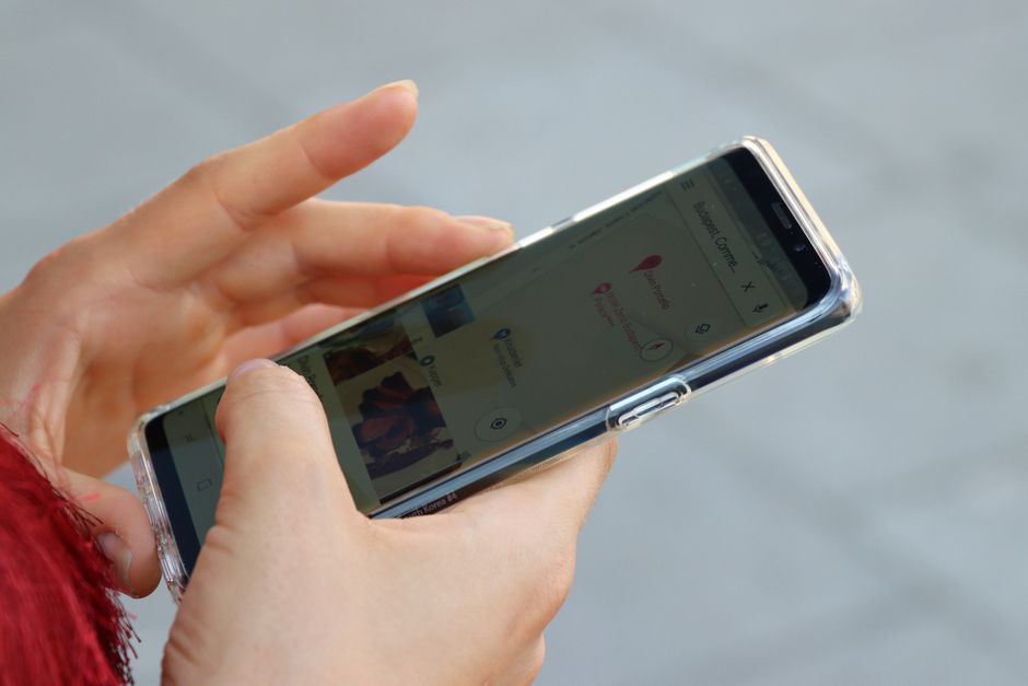 Traveler using a map app on a smartphone in a bustling Chinese city