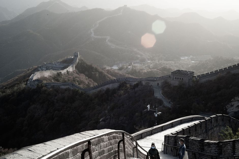 Traveler enjoying the Great Wall of China, symbolizing safe and adventurous travel with insurance