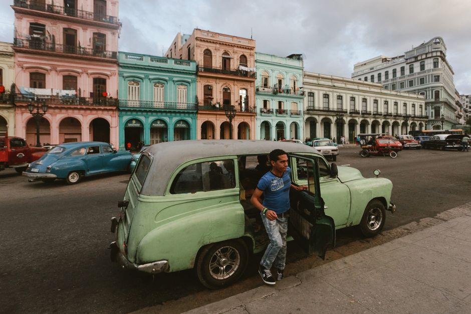 Vibrant street scene in Old Havana, Cuba, with classic cars and historic architecture