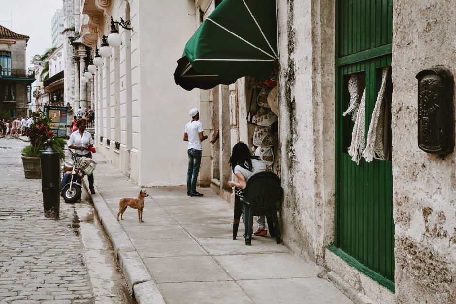 A vibrant street market scene in Cuba with local crafts and people shopping