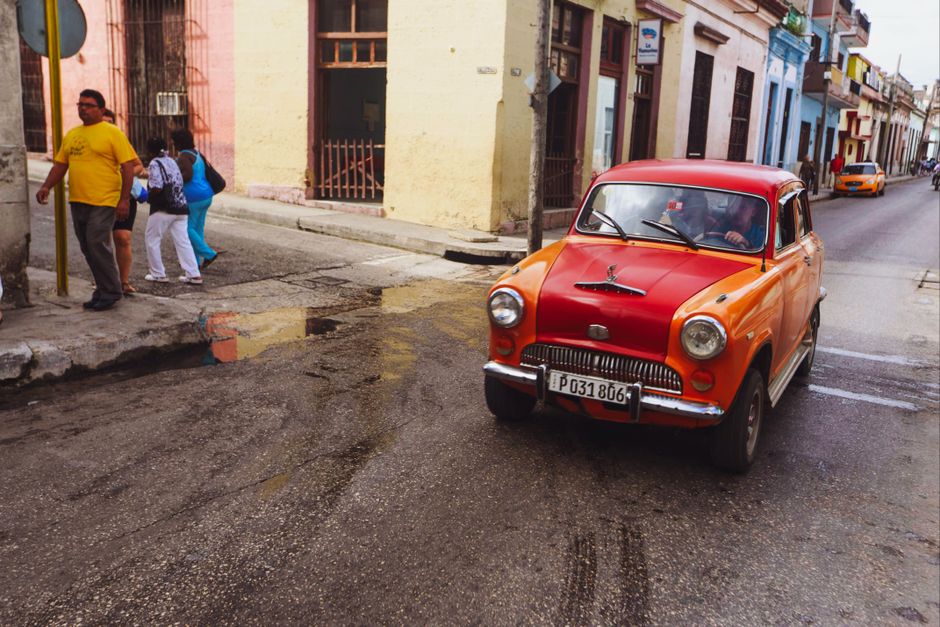 A vibrant street scene in Havana, Cuba, with a classic vintage car, symbolizing travel and adventure.