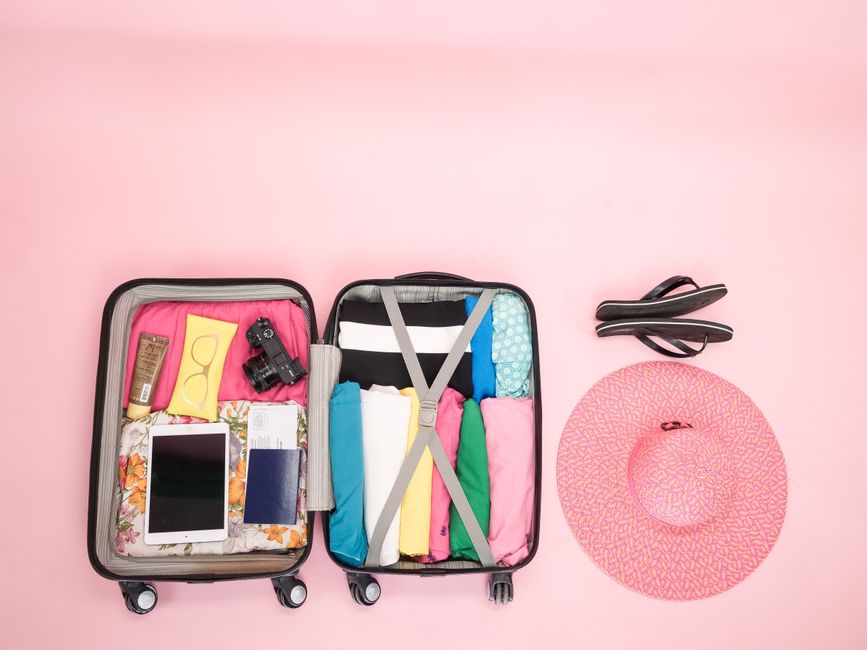 Essential items for a Jamaica beach vacation, including a hat, sunglasses, and reef-safe sunscreen.