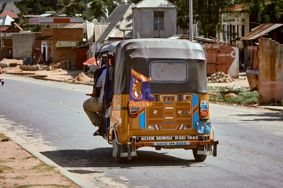 A vibrant street scene in Jamaica with local transport and people