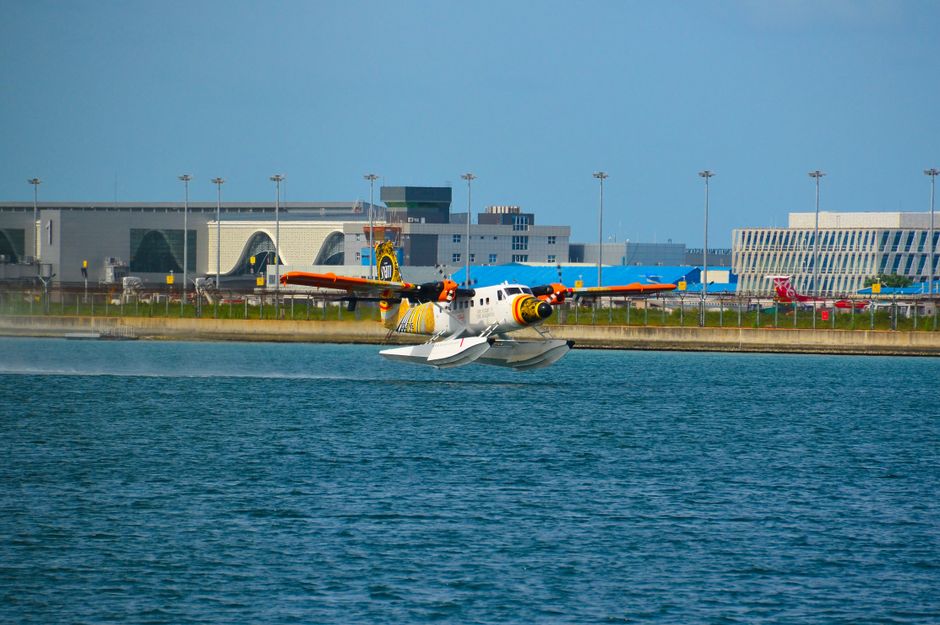 A seaplane landing near a luxury resort in the Maldives, showcasing island transportation.