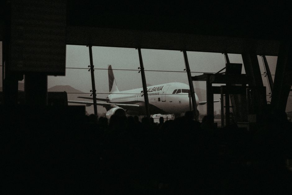 Passengers waiting patiently at a modern airport terminal in the Maldives due to a flight delay