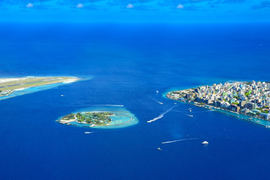 Aerial view of a Maldivian island resort with clear turquoise waters, symbolizing navigation and exploration