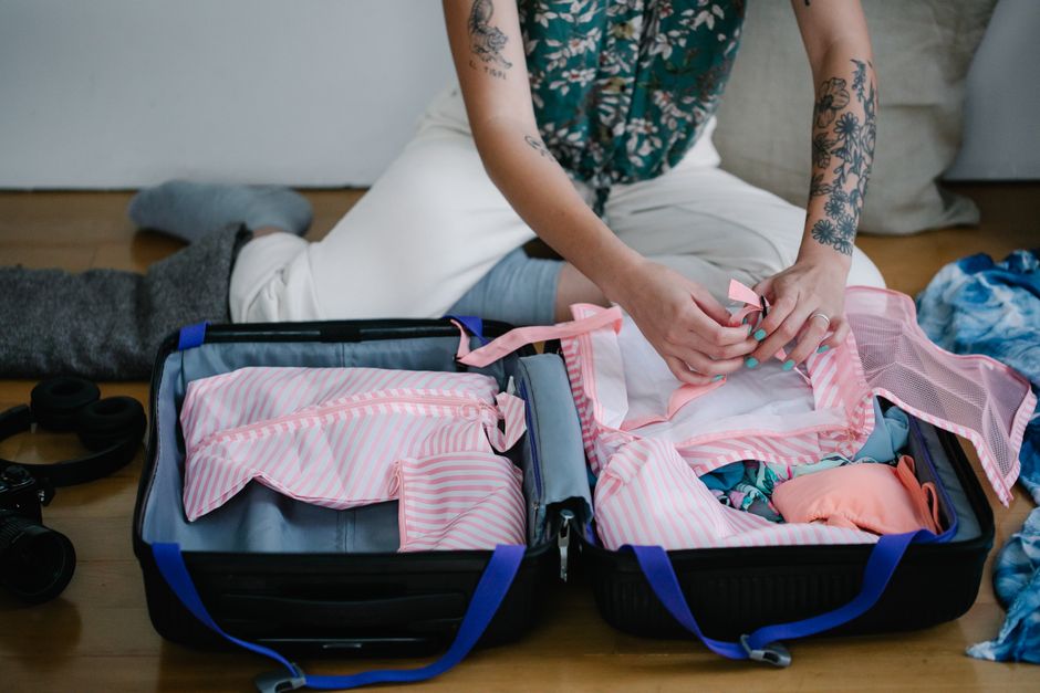 Open suitcase with lightweight clothing and travel essentials for a Maldives vacation