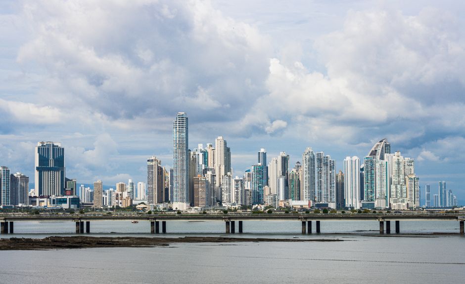 Panama City skyline with modern buildings and lush tropical trees, illustrating a vibrant travel destination