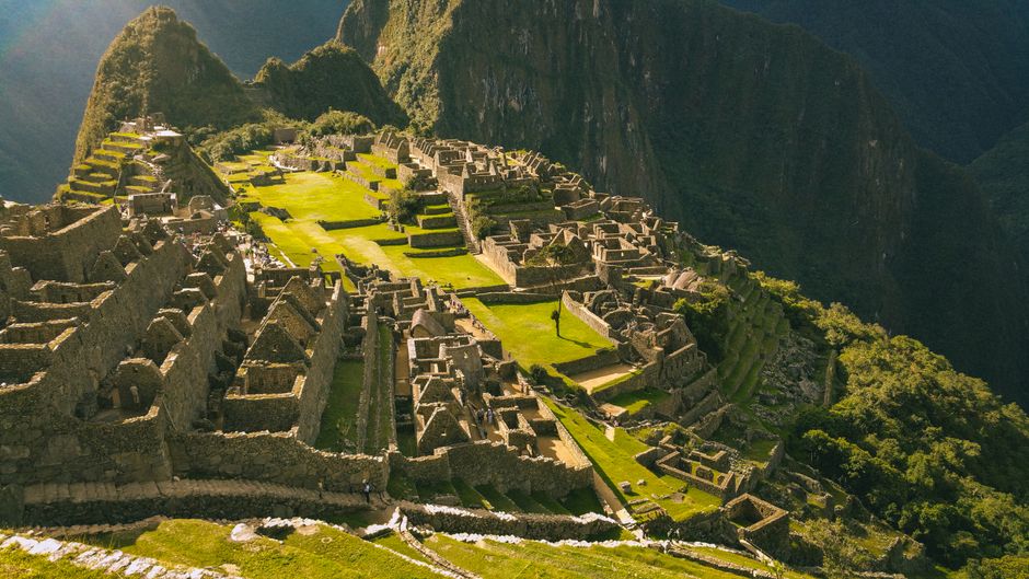 Traveler with backpack overlooking Machu Picchu, Peru