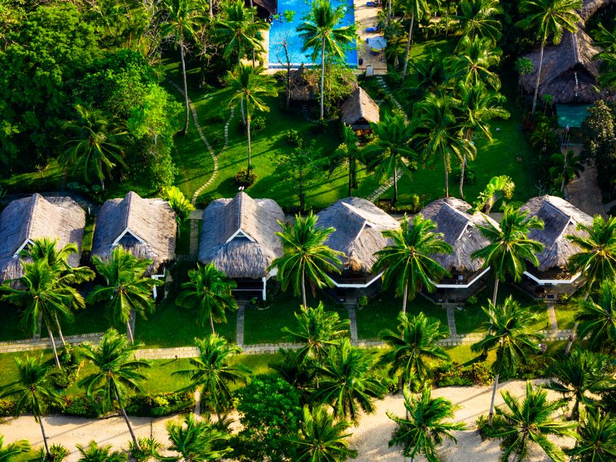 Stunning beachfront resort in the Philippines with palm trees and clear blue water