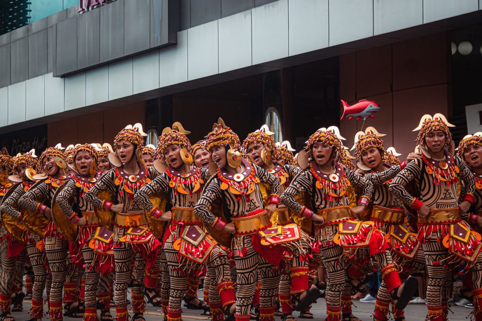 People celebrating Sinulog Festival in Cebu City, Philippines with colorful costumes and traditional dances