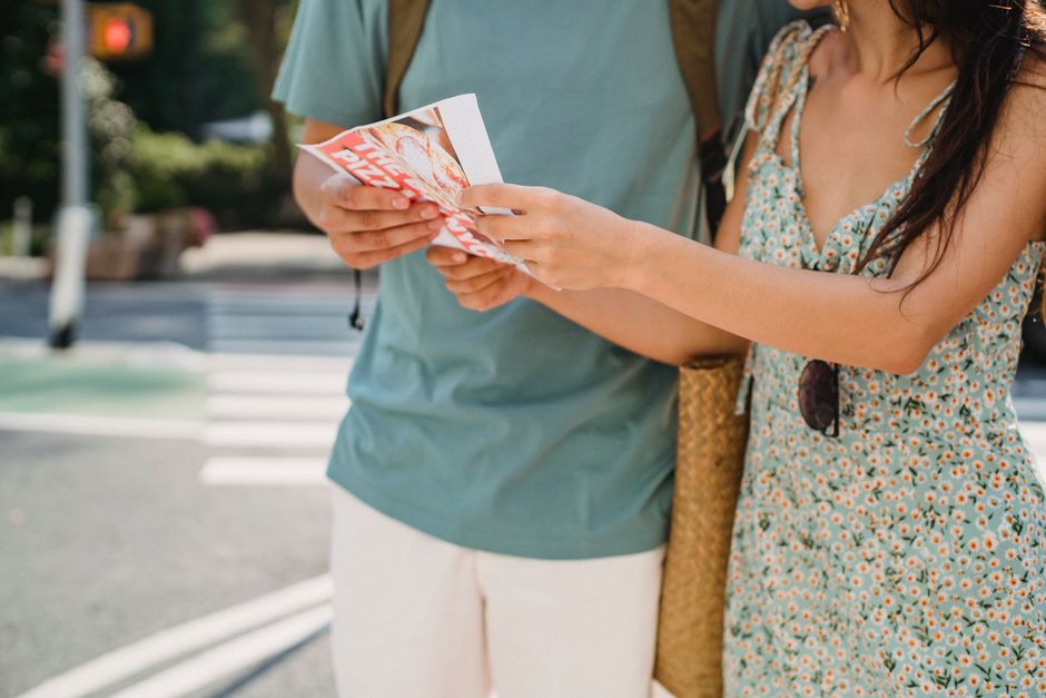 Tourist navigating a street in the Philippines using a smartphone map app