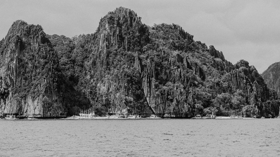 Stunning limestone cliffs and clear blue waters of El Nido, Palawan, Philippines during an island hopping tour.