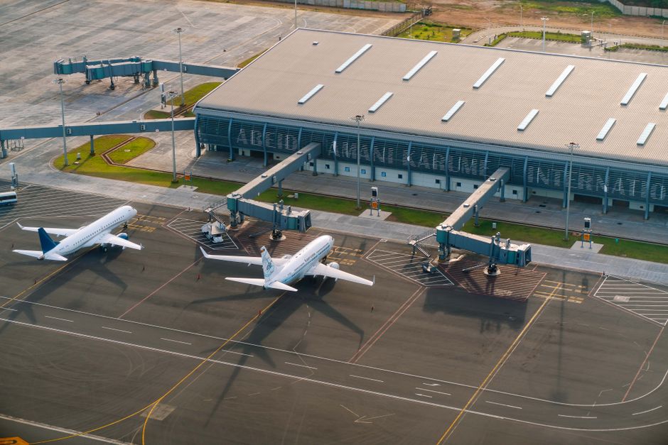 Busy Ninoy Aquino International Airport terminal in the Philippines with travelers and signage