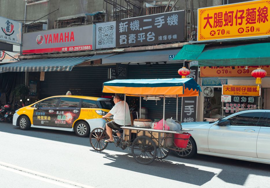 Vibrant night market scene in Taiwan with bustling food stalls and people enjoying local delicacies