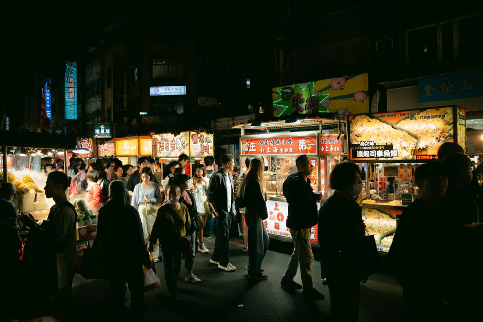 Vibrant night market street scene in Taiwan with people enjoying local food