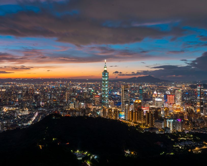 Vibrant Taipei 101 skyline at dusk in Taiwan, showcasing the city's modern appeal