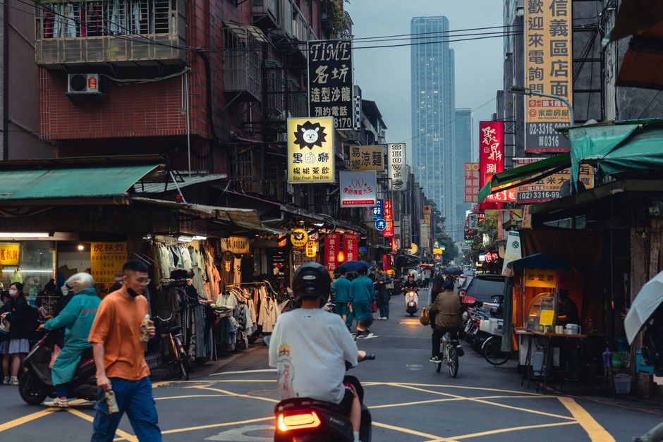 Vibrant Shilin Night Market in Taiwan with various food stalls and shoppers